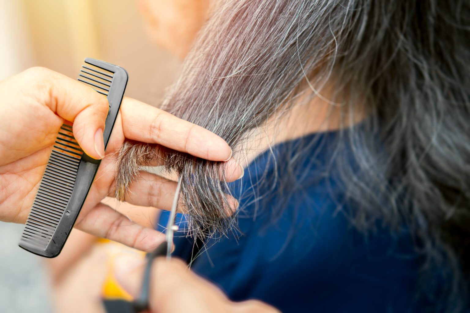 A woman at a skilled nursing facility getting her hair done at a salon