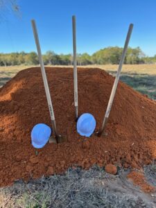 Groundbreaking shovels placed in a dirt mound at the future Bailey Creek Health and Rehab skilled nursing facility.