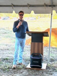 Speaker addressing attendees at the Bailey Creek Health and Rehab groundbreaking ceremony.
